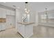 Open kitchen with island, granite countertop, and view towards the stairway at 13913 Hahn Ln, Orlando, FL 32827