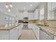 Bright kitchen with island, stainless steel appliances, and open view to living area at 13913 Hahn Ln, Orlando, FL 32827