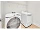 A laundry room that features a front load washer and dryer, tiled floors and a wire rack at 13913 Hahn Ln, Orlando, FL 32827
