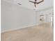 Open living room with light wood floors and view into kitchen and dining room at 13913 Hahn Ln, Orlando, FL 32827
