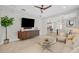 Bright living room with modern furnishings, TV, and ceiling fan showcasing open floor plan at 13913 Hahn Ln, Orlando, FL 32827