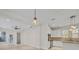 Bright and open living space with a modern ceiling fan flowing seamlessly into the kitchen with stone countertops at 13913 Hahn Ln, Orlando, FL 32827