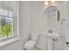 Cozy powder room with a pedestal sink and window at 13913 Hahn Ln, Orlando, FL 32827