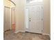 Inviting foyer features beautiful tile flooring, a closet, and a view into the adjoining room at 14155 Portrush Dr, Orlando, FL 32828