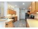 Kitchen area with stainless steel appliances, wood cabinetry and tiled floor at 14155 Portrush Dr, Orlando, FL 32828