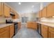Kitchen area with stainless steel appliances, wood cabinetry and tiled floors at 14155 Portrush Dr, Orlando, FL 32828