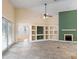 Open-concept living room with tile floors, a fireplace, built-in shelves, and access to the outdoor pool area at 14155 Portrush Dr, Orlando, FL 32828