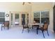 This covered patio features a table and chairs and access to the outdoors at 14155 Portrush Dr, Orlando, FL 32828