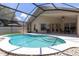 The enclosed pool area is complemented by a covered patio and outdoor dining set at 14155 Portrush Dr, Orlando, FL 32828