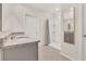 Bathroom featuring granite countertop, framed mirror, and walk-in shower at 1541 Tali Ln, Mount Dora, FL 32757