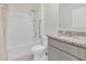 Bathroom featuring a shower and tub combination, white tile, and a granite countertop at 1541 Tali Ln, Mount Dora, FL 32757