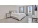 Bright bedroom with large windows, gray tile floors, and a comfortable bed at 1541 Tali Ln, Mount Dora, FL 32757