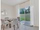 Cozy breakfast nook with a glass table, comfortable seating, soft light, and backyard view at 1541 Tali Ln, Mount Dora, FL 32757