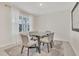 Cozy dining room featuring a modern table, soft lighting, neutral décor, and a large window at 1541 Tali Ln, Mount Dora, FL 32757