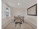 Cozy dining room featuring a modern table, soft lighting, neutral décor, and a large decorative mirror at 1541 Tali Ln, Mount Dora, FL 32757