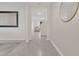 Inviting hallway with tile flooring, neutral walls, and decorative mirrors leading to the living room and staircase at 1541 Tali Ln, Mount Dora, FL 32757