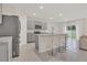 Spacious kitchen with grey cabinets, granite counters, stainless steel appliances, and a large island with seating at 1541 Tali Ln, Mount Dora, FL 32757
