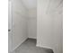 Walk-in closet with wire shelving and tile flooring for organization and storage at 1541 Tali Ln, Mount Dora, FL 32757
