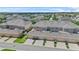 An aerial view of townhomes, showcasing garages and landscaping at 15651 Kinnow Mandarin Ln, Winter Garden, FL 34787