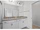Bathroom showcasing double vanity with granite countertop and modern fixtures at 15651 Kinnow Mandarin Ln, Winter Garden, FL 34787