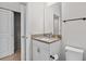 Well-lit bathroom with a granite countertop vanity and modern fixtures offering both style and functionality at 15651 Kinnow Mandarin Ln, Winter Garden, FL 34787
