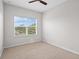 Bright bedroom with a carpet and a window overlooking the neighborhood creates a peaceful space at 15651 Kinnow Mandarin Ln, Winter Garden, FL 34787
