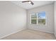 Cozy bedroom with a carpet, ceiling fan, and a window offers a relaxing space for rest and rejuvenation at 15651 Kinnow Mandarin Ln, Winter Garden, FL 34787