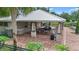 Outdoor community space features shaded seating, granite counters, and a charming brick patio at 15651 Kinnow Mandarin Ln, Winter Garden, FL 34787