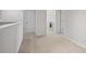 Bright hallway area leading to a laundry room with modern washer and dryer units at 15651 Kinnow Mandarin Ln, Winter Garden, FL 34787