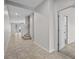 Hallway featuring tile floors and a staircase at 15651 Kinnow Mandarin Ln, Winter Garden, FL 34787