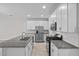 Modern kitchen with granite countertops, stainless appliances, and white cabinets at 15651 Kinnow Mandarin Ln, Winter Garden, FL 34787