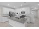 Bright kitchen with a large island, granite countertops, and stainless appliances at 15651 Kinnow Mandarin Ln, Winter Garden, FL 34787