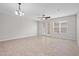 Spacious living room with tile floors and a view of the backyard, creating a bright and welcoming space for relaxing at 15651 Kinnow Mandarin Ln, Winter Garden, FL 34787