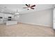 Open-concept living room with tile floors, ceiling fan, and modern lighting fixtures is great for entertaining guests at 15651 Kinnow Mandarin Ln, Winter Garden, FL 34787
