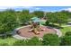 Community playground offers a safe and fun play area amidst lush greenery and trees at 15651 Kinnow Mandarin Ln, Winter Garden, FL 34787