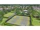 Aerial view of community tennis courts, pool, and picnic area amidst lush greenery at 15651 Kinnow Mandarin Ln, Winter Garden, FL 34787