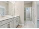 Modern bathroom with double vanity, quartz countertop and glass-door shower at 16460 Silver Brook Way, Winter Garden, FL 34787