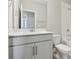 Bright bathroom features a vanity with white countertops and a large mirror at 16460 Silver Brook Way, Winter Garden, FL 34787