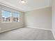 Spacious bedroom features neutral carpet and ample natural light from two windows at 16460 Silver Brook Way, Winter Garden, FL 34787