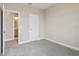 Bedroom with a neutral carpet, paint, and a door leading to a bathroom with a view at 16460 Silver Brook Way, Winter Garden, FL 34787