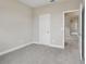 Bedroom with neutral carpet and paint with a door opening to another room, creating a cozy space at 16460 Silver Brook Way, Winter Garden, FL 34787