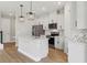 Modern kitchen with white cabinetry, stainless steel appliances, and island with pendant lighting at 16460 Silver Brook Way, Winter Garden, FL 34787