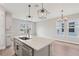 Bright kitchen featuring island, quartz countertops, stainless steel appliances and ample natural light at 16460 Silver Brook Way, Winter Garden, FL 34787
