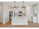 Modern kitchen featuring white cabinetry, stainless steel appliances, and a center island, perfect for cooking and entertaining at 16460 Silver Brook Way, Winter Garden, FL 34787