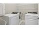 Convenient laundry room with modern, white washer and dryer at 16460 Silver Brook Way, Winter Garden, FL 34787