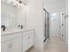 Bathroom with double vanity, stone countertop, black hardware, and a glass shower at 16544 Silver Brook Way, Winter Garden, FL 34787