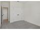 A bedroom with light gray carpeting, bright white trim, and a spacious closet at 16544 Silver Brook Way, Winter Garden, FL 34787
