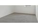 An empty bedroom featuring neutral carpet, white walls and trim, and a bright window at 16544 Silver Brook Way, Winter Garden, FL 34787