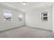 Empty bedroom with neutral carpet and three large windows at 16544 Silver Brook Way, Winter Garden, FL 34787