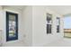 Covered front porch featuring a glass paneled front door and views of the outdoors at 16544 Silver Brook Way, Winter Garden, FL 34787